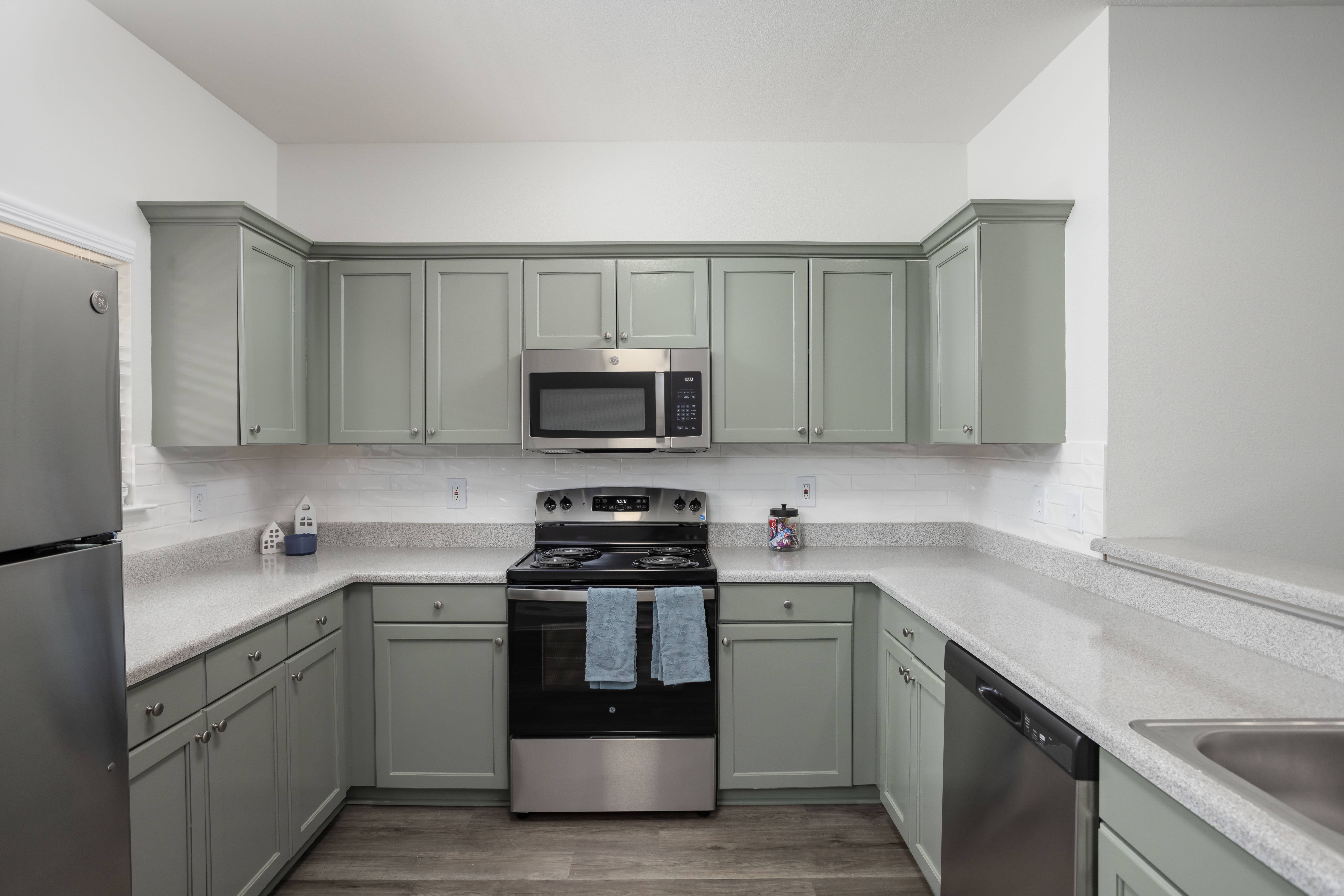 A kitchen with a stove, oven, and refrigerator.